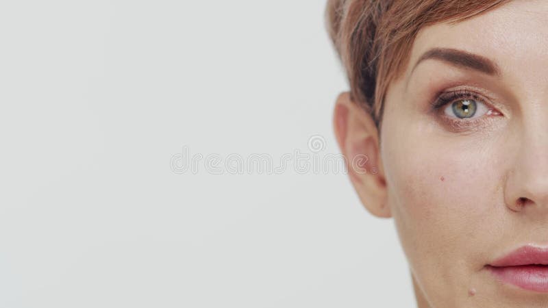 Le gros plan du milieu de la femme mûre au-dessus du fond blanc. Portrait de femme mûre. Les injections de beauté de chirurgie pla clips vidéos