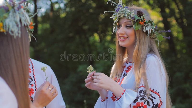 Le groupe des jeunes dans des costumes nationaux slaves célèbrent le solstice d'été Un groupe de filles et de garçons parlant et clips vidéos