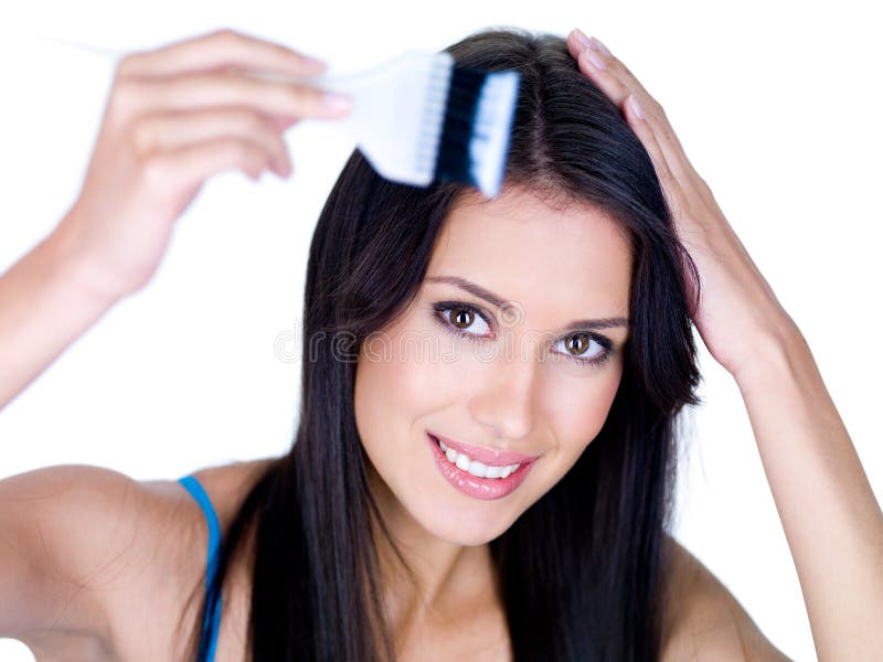 Portrait of young smiling woman coloring her long brown hair - isolated. Portrait of young smiling woman coloring her long brown hair - isolated