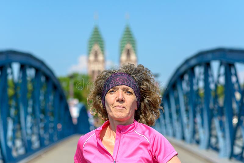 Le kvinnan som joggar över en stads- bro arkivbilder Le kvinnan som joggar över en stads- bro arkivbilder