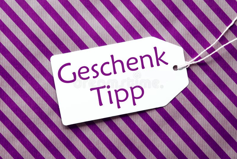 Le label sur le papier d'emballage pourpre, Geschenk Tipp signifie l'astuce de cadeau photographie stock Le label sur le papier d'emballage pourpre, Geschenk Tipp signifie l'astuce de cadeau photographie stock