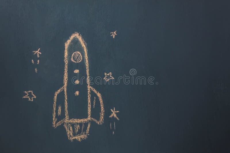 Top view / Flat lay Handmade drawing rocket ship launch / take off to the space with star on the blackboard by chalk board. Top view / Flat lay Handmade drawing rocket ship launch / take off to the space with star on the blackboard by chalk board.