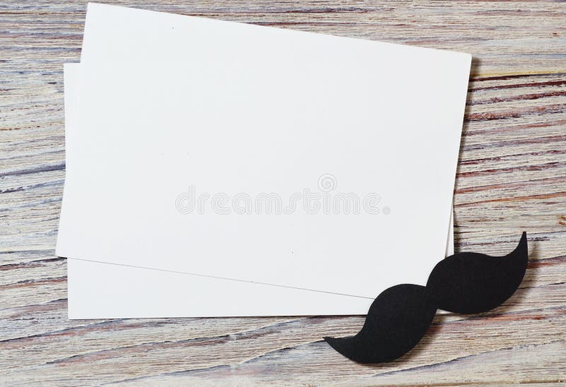 Le livre blanc enveloppent sur la vieille table en bois avec le ton de cru Moustache de papier noire Le jour de père heureux - mo photos stock Le livre blanc enveloppent sur la vieille table en bois avec le ton de cru Moustache de papier noire Le jour de père heureux - mo photos stock