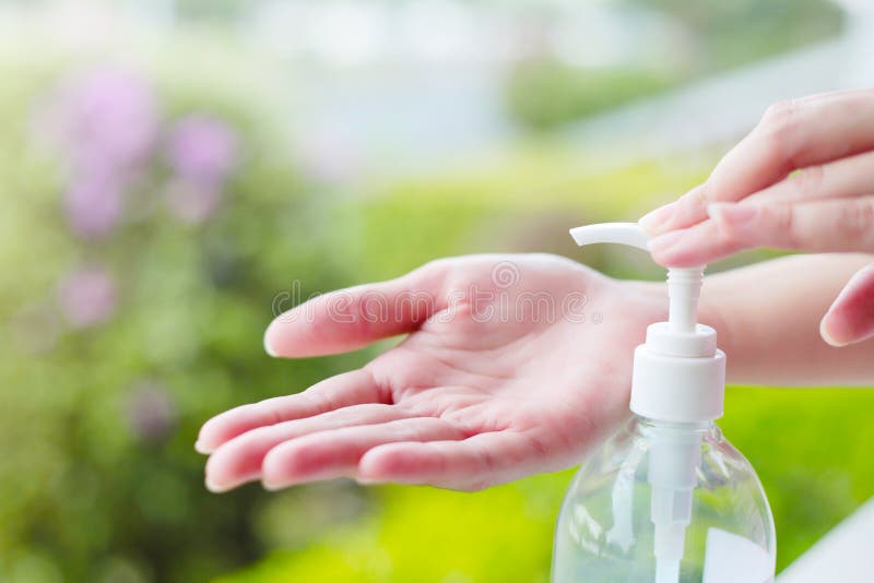 Le mani femminili facendo uso di lavaggio passano l'erogatore della pompa del gel del prodotto disinfettante fotografia stock libera da diritti Le mani femminili facendo uso di lavaggio passano l'erogatore della pompa del gel del prodotto disinfettante fotografia stock libera da diritti