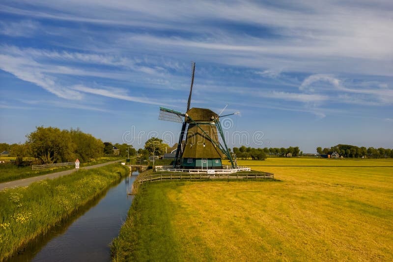 The Nightingale windmill in the middle of farm lands in Northern Netherlands. The Nightingale windmill in the middle of farm lands in Northern Netherlands