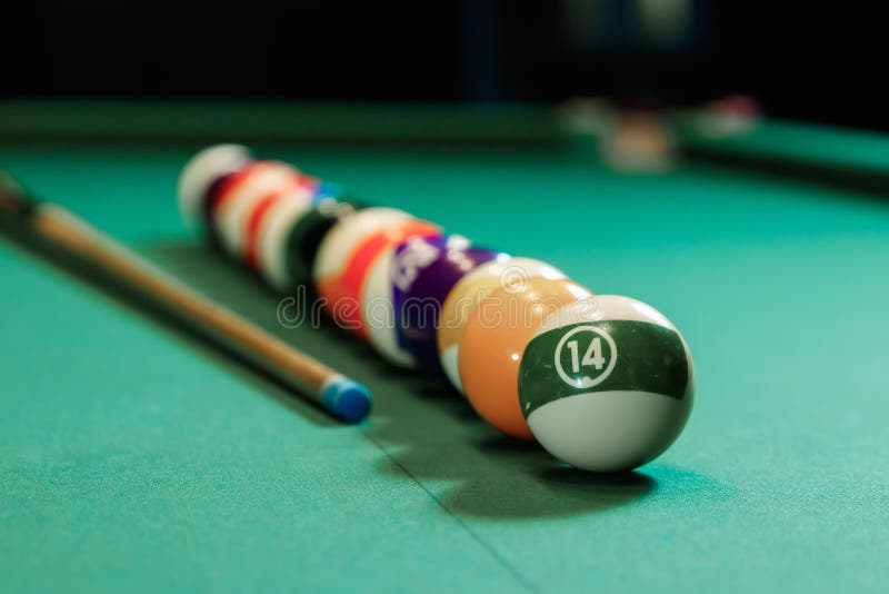 Billiard balls are lined up on a billiard table, American billiards. Sports games, outdoor activities. Billiard balls are lined up on a billiard table, American billiards. Sports games, outdoor activities.