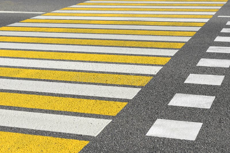 Asphalt road crosswalk with marking lines white and yellow stripes background. Asphalt road crosswalk with marking lines white and yellow stripes background