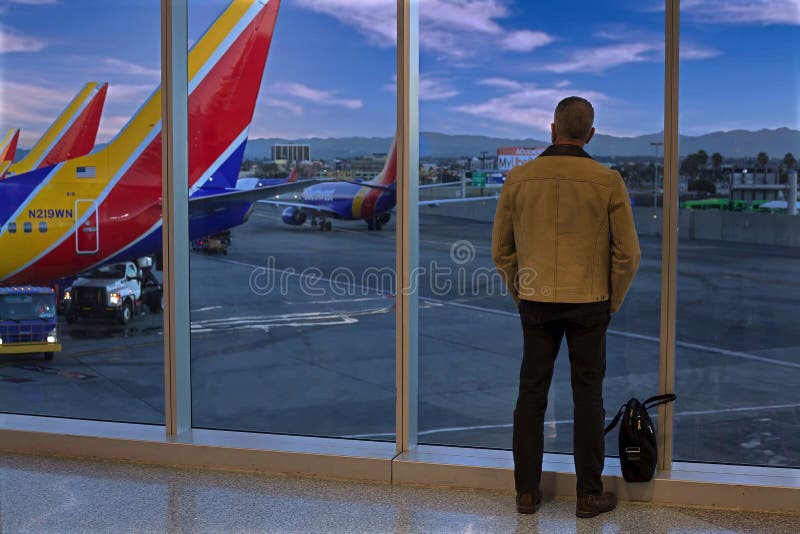 Southwest Airlines passenger looks out window at departure gate in Los Angeles. Southwest Airlines passenger looks out window at departure gate in Los Angeles