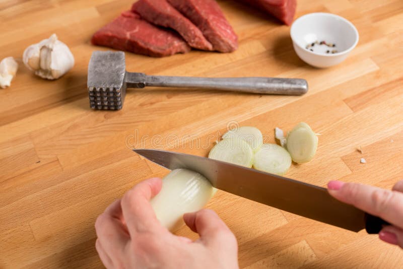 Pinces Tenant Un Morceau De Viande. La Main Masculine Tient Une Planche De  Bois. Boeuf Frit Au Piment. Le Chef Du Restaurant Prépare Des Médaillons.