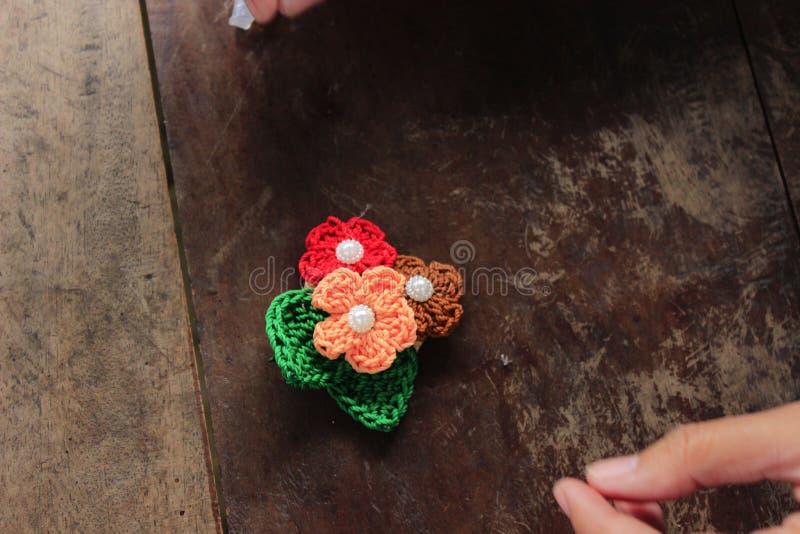 The Process of Making Crochet Flowers - 3 flowers are already attached to 2 leaves. This is basic of Making Crochet. The Process of Making Crochet Flowers - 3 flowers are already attached to 2 leaves. This is basic of Making Crochet.