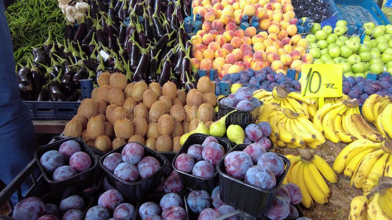 Le prugne di frutta kiwi sono in fila sul mercato pubblico