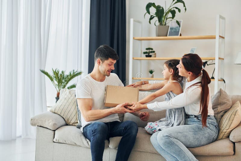 Le père en vêtements décontractés est à la maison avec sa femme et sa fille images stock