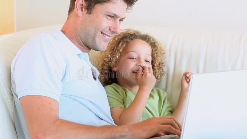 Le père heureux enseigne à son fils comment utiliser un ordinateur portable clips vidéos