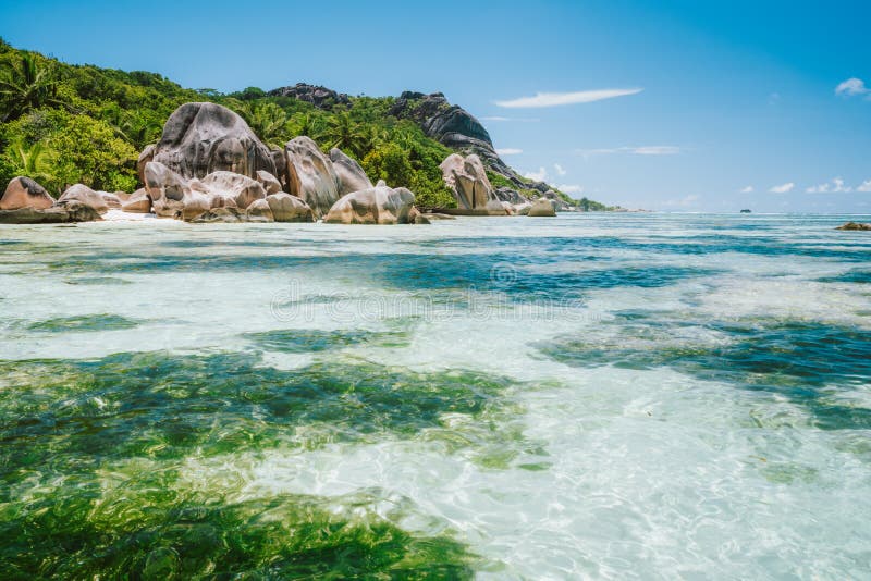 La Digue island, Seychelles. World famous paradise beach Anse Source d&#x27;Argent with shallow blue lagoon, granite boulders. La Digue island, Seychelles. World famous paradise beach Anse Source d&#x27;Argent with shallow blue lagoon, granite boulders.
