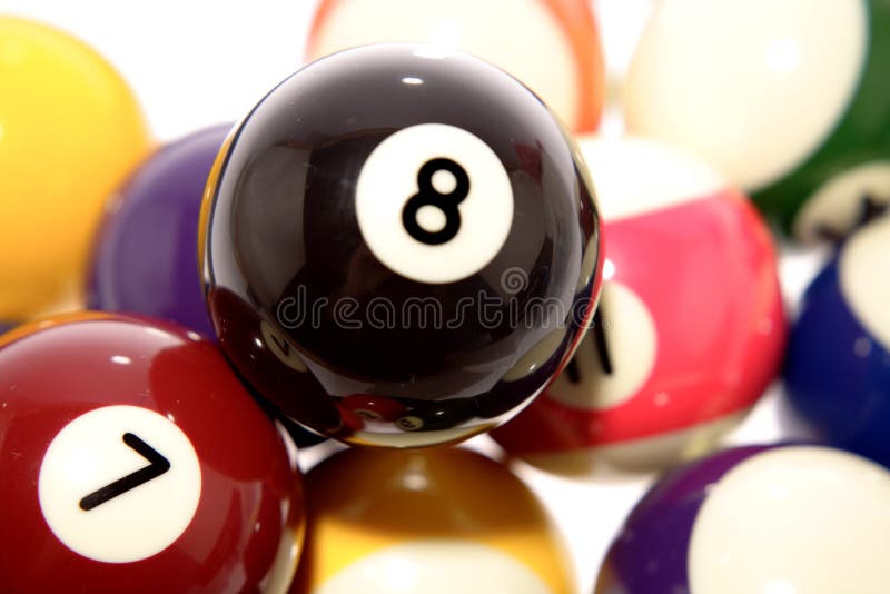 Close up of set of billiard balls, focus on black number eight ball in foreground. Close up of set of billiard balls, focus on black number eight ball in foreground.