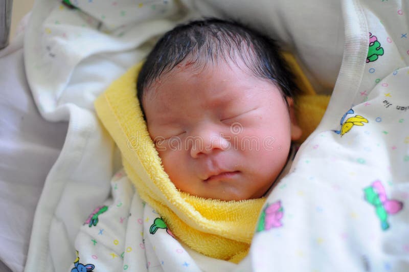 The newborn infant sleeping in swaddling clothes. The newborn infant sleeping in swaddling clothes