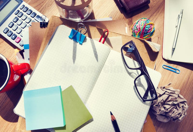 Messy Designer's Table with Blank Note and Tools. Messy Designer's Table with Blank Note and Tools.