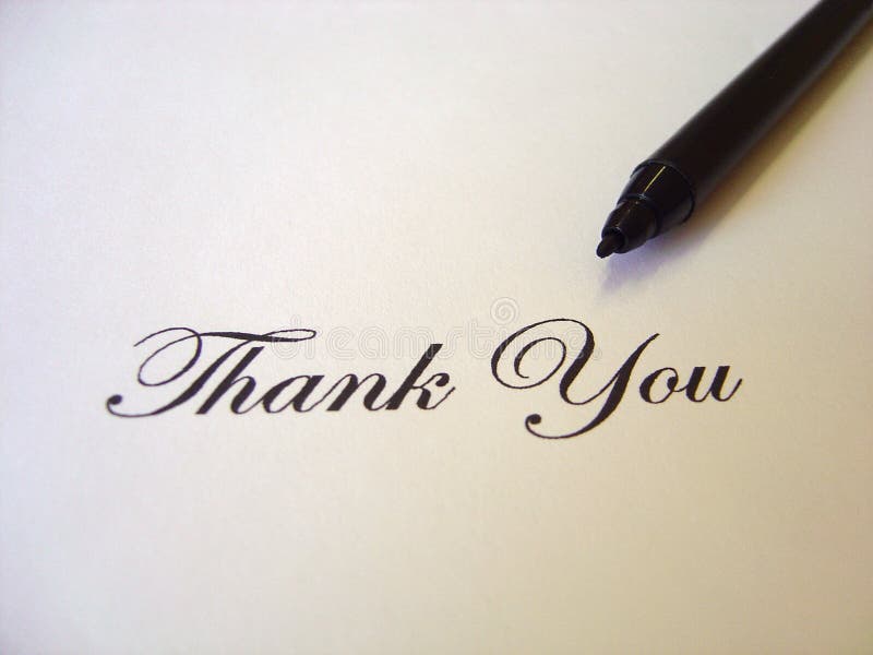 Close up view of the words THANK YOU written in classic type and a black pen on a white paper sheet. Close up view of the words THANK YOU written in classic type and a black pen on a white paper sheet