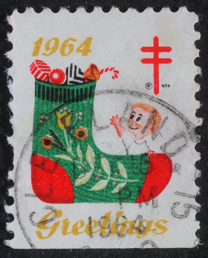 Le timbre de Noël imprimé aux Etats-Unis montre un bas avec des cadeaux photo stock Le timbre de Noël imprimé aux Etats-Unis montre un bas avec des cadeaux photo stock