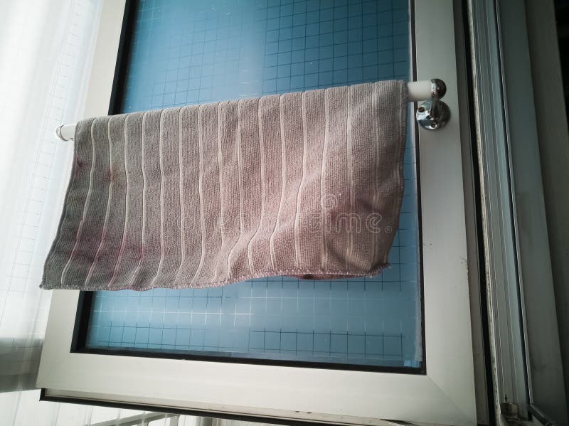 Kitchen microfiber cloth drying at the window mounted aluminium and pvc pipe towel rack. Home DIY project hack to the window. Kitchen microfiber cloth drying at the window mounted aluminium and pvc pipe towel rack. Home DIY project hack to the window.
