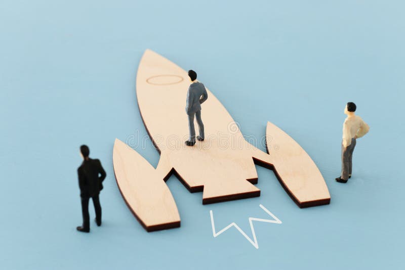 Leadership and teamwork concept miniature people and rocket, inspiration and vision. royalty free stock photos