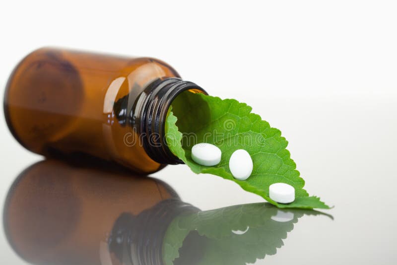 Leaf and Pills in a Small Bottle Stock Photo - Image of container ...