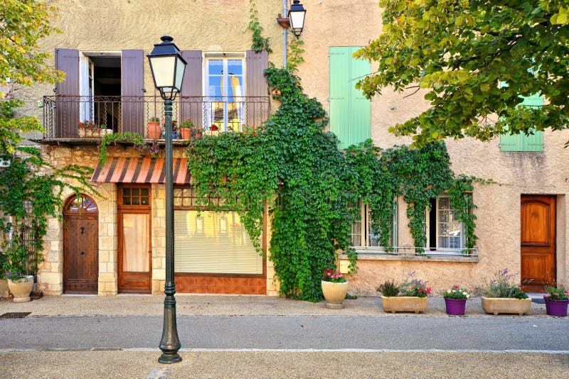 Leafy house fronts with shuttered windows, Provence, France