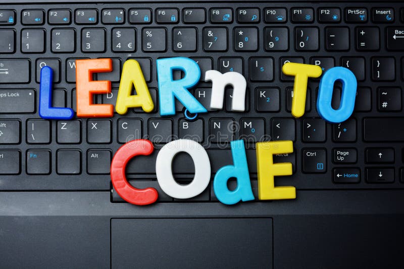 Learn to code advice from colorful letters on notebook keyboard royalty free stock photography Learn to code advice from colorful letters on notebook keyboard royalty free stock photography
