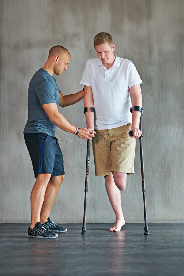 Learning To Walk Again. Studio Shot of a Young Amputee Training in a