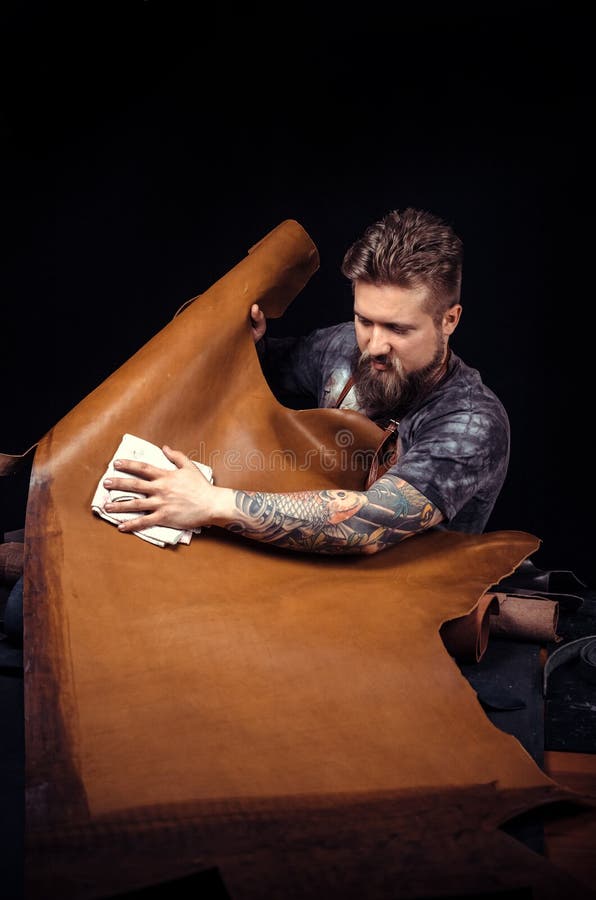 Leather Artist Working on a New Leather Product in Leather Studio Stock