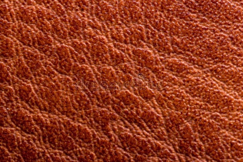 Leather background texture. Closeup of genuine red brown leather detail for design work. High resolution image or macro stock images