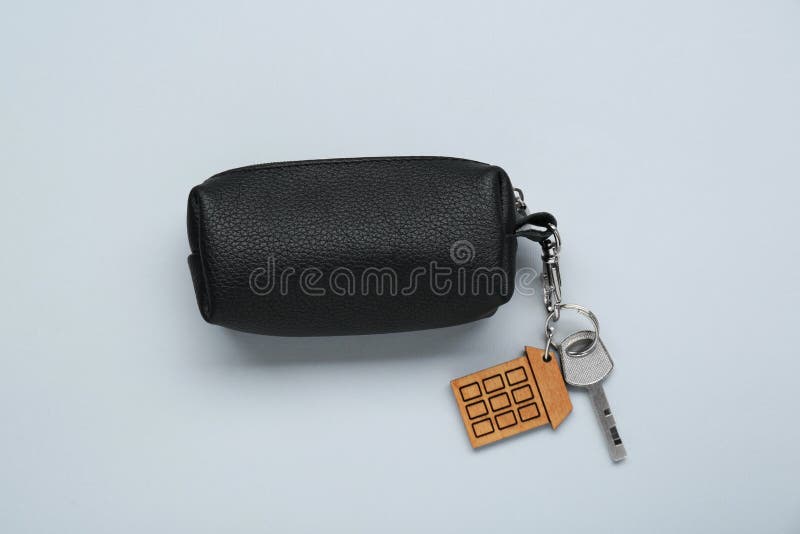 Leather case with key on light grey background. Leather case with key on light grey background