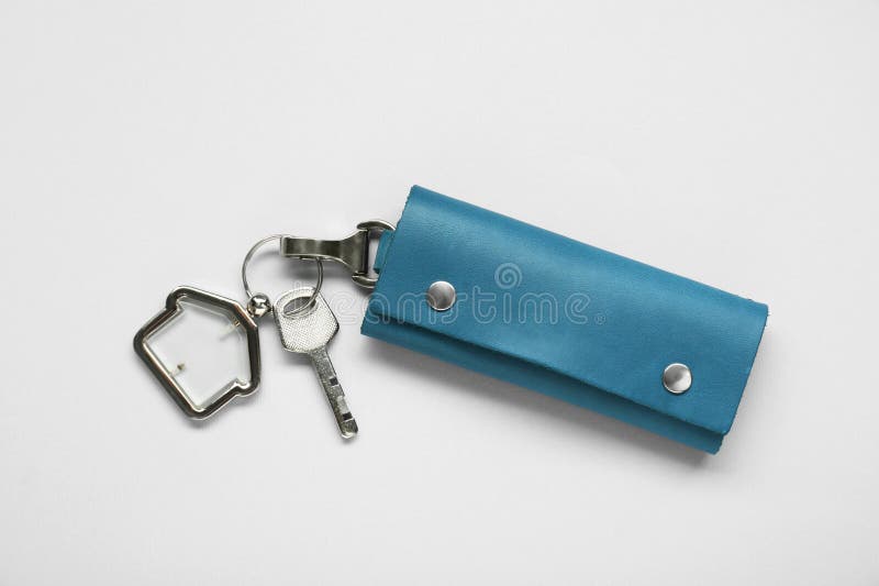 Leather case with key on light grey background. Leather case with key on light grey background