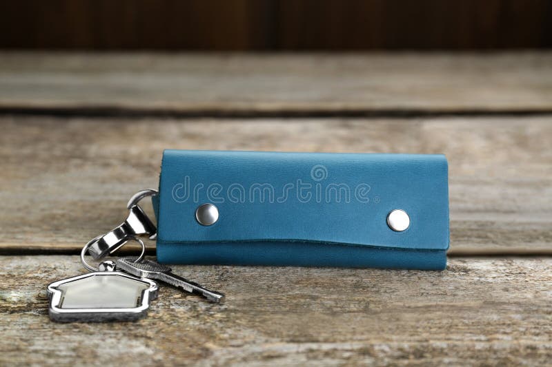 Leather case with key on old wooden table. Leather case with key on old wooden table