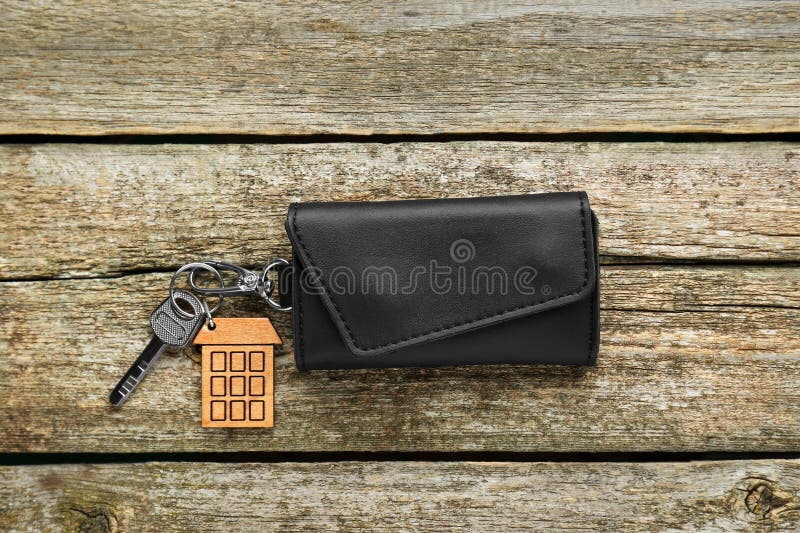 Leather case with key on old wooden table. Leather case with key on old wooden table