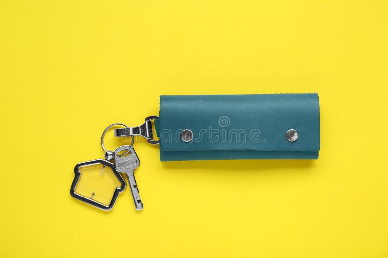 Leather case with key on yellow background. Leather case with key on yellow background