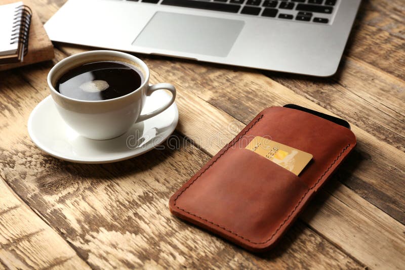 Leather case with mobile phone, laptop and cup