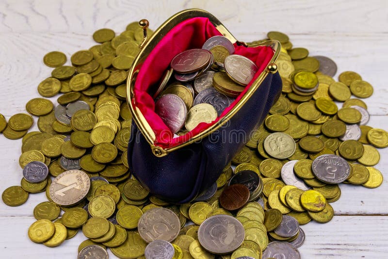 Leather change purse with coins on white wooden background royalty free stock photography Leather change purse with coins on white wooden background royalty free stock photography