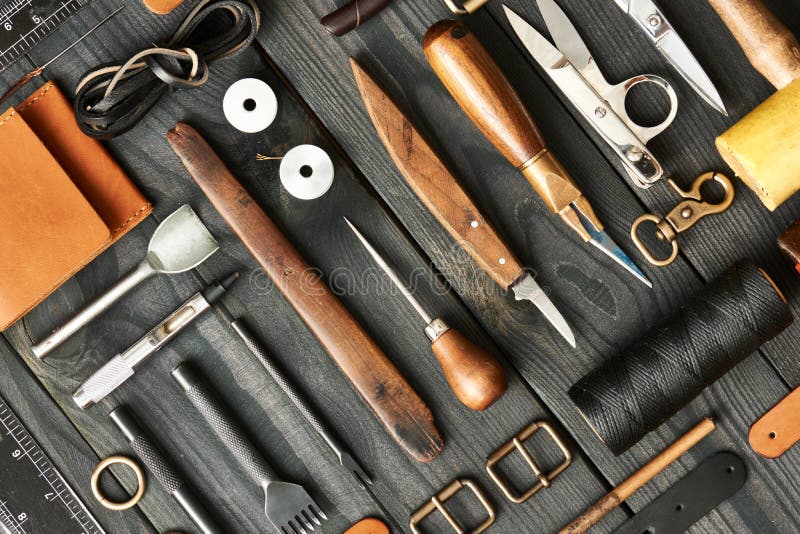 Leather Working Tools And Rolled Up Hide Organized Stock Photo