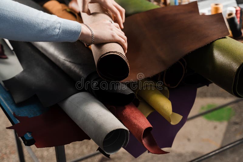 Leather Craftsman is Touching Roll of Genuine Leather in the