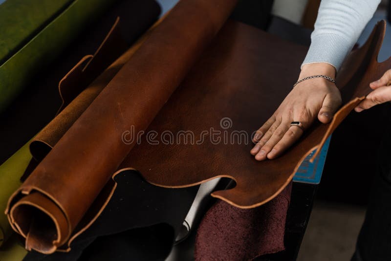Leather Craftsman is Touching Roll of Genuine Leather in the