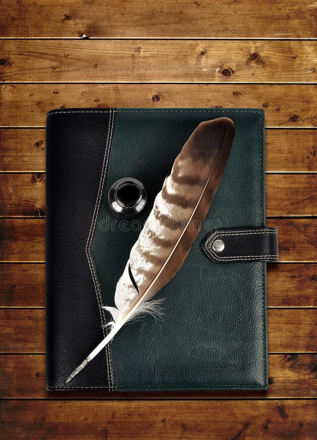 Leather notebook and feather with ink bottle. royalty free stock image