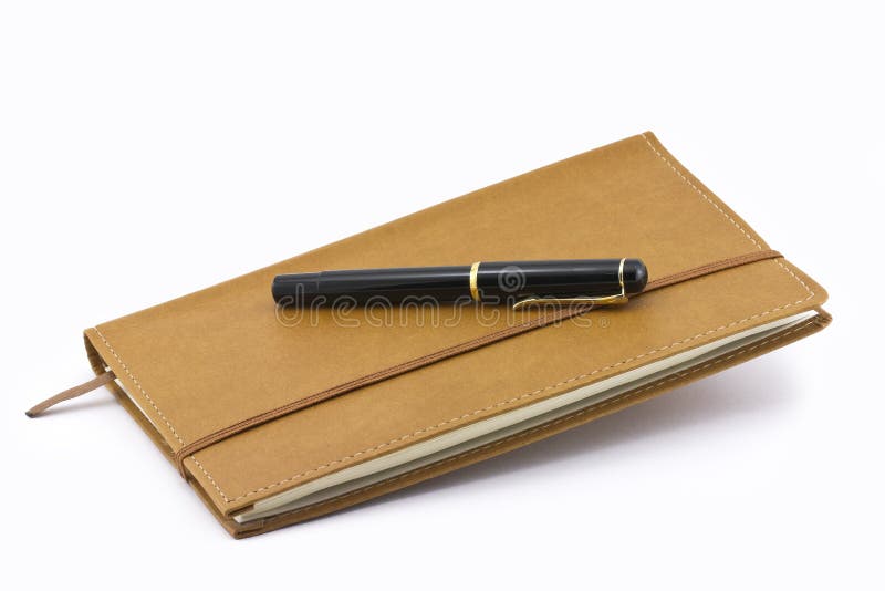 Leather notebook and pen isolated royalty free stock images