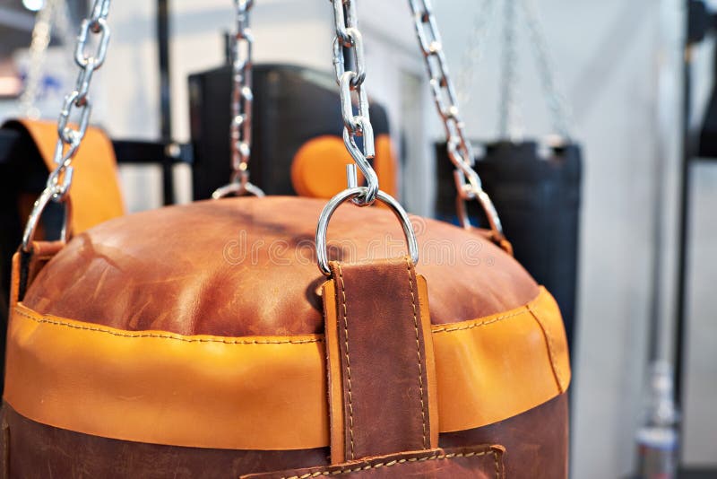 Leather Punching Bag Hanging on Steel Chains on Black. Stock Image