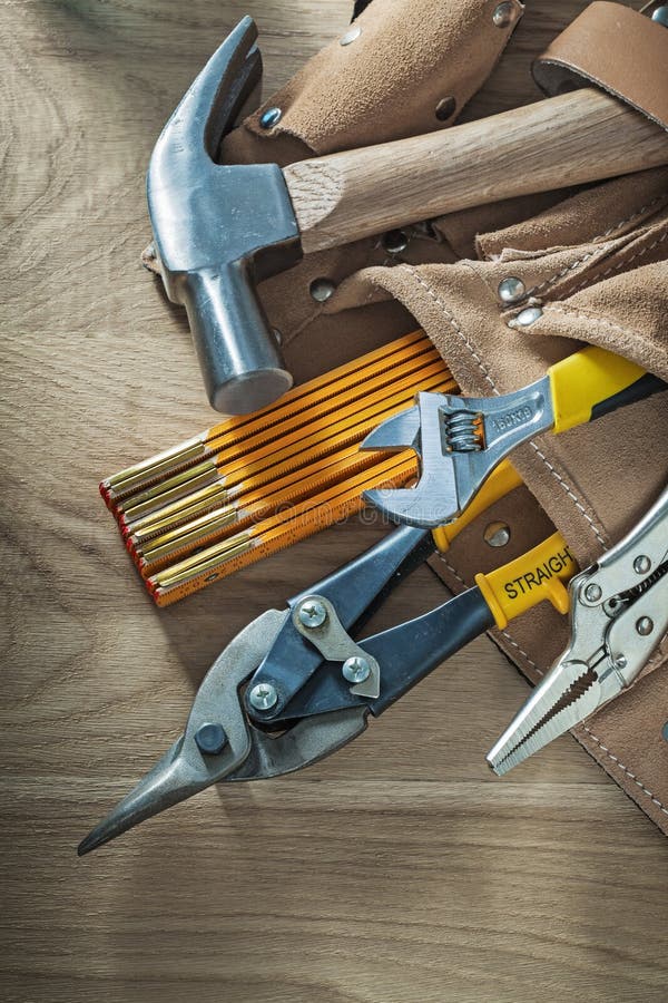 Leather Tool Belt with Construction Tooling on Wooden Board Stock Photo