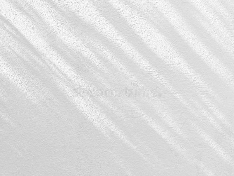 Leaves Shadow on White Peeling Painting on Concrete Wall Texture Background. royalty free stock photos