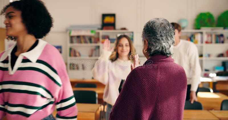 Leaving, high five and teacher with students in classroom for motivation, education and support. Greeting, professor and stock footage