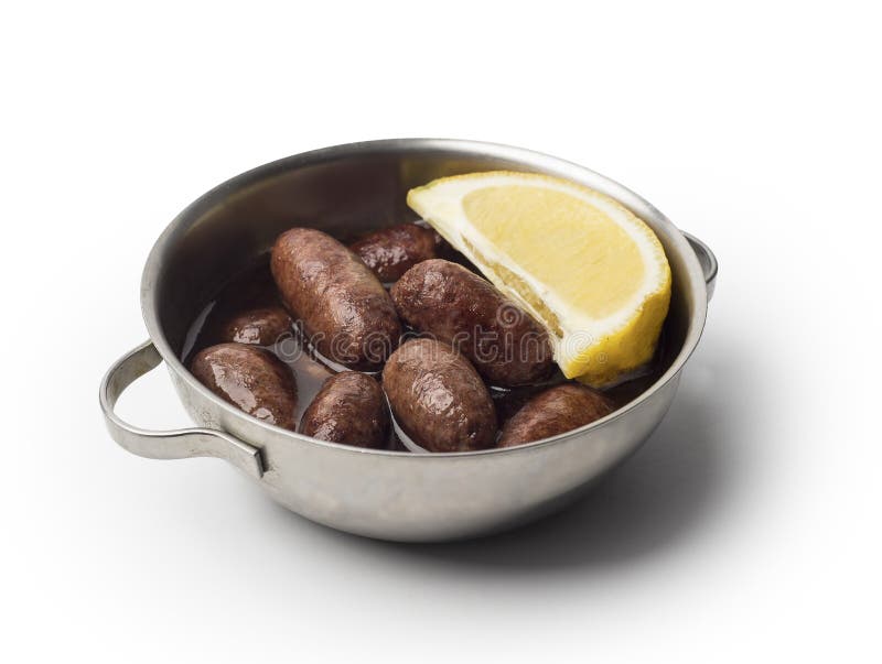 Lebanese starters of Makanek meat marinated, sausages fried in a metal pan