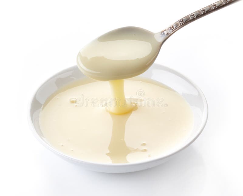 Leche condensada de colada foto de archivo Leche condensada de colada foto de archivo
