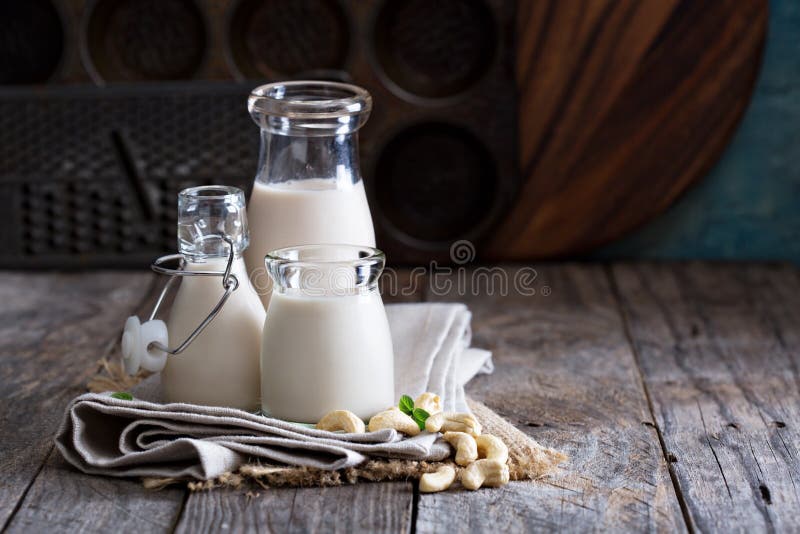 Cashew nut vegan milk non dairy in different bottles with copy space. Cashew nut vegan milk non dairy in different bottles with copy space